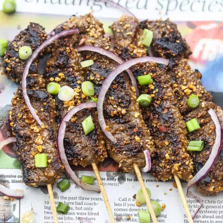 beef skewers on newspaper