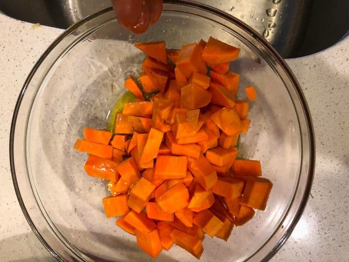 diced sweet potatoes in a bowl with olive oil