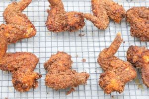 fried chicken wings resting on a tray