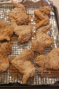 raw breaded chicken resting on rack