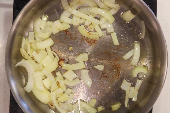 onions sauteing in a skillet