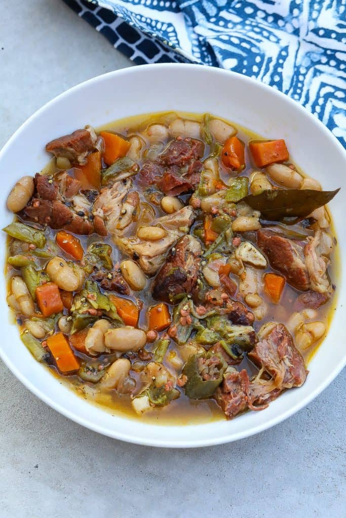 white bean stew with ham hocks in a bow