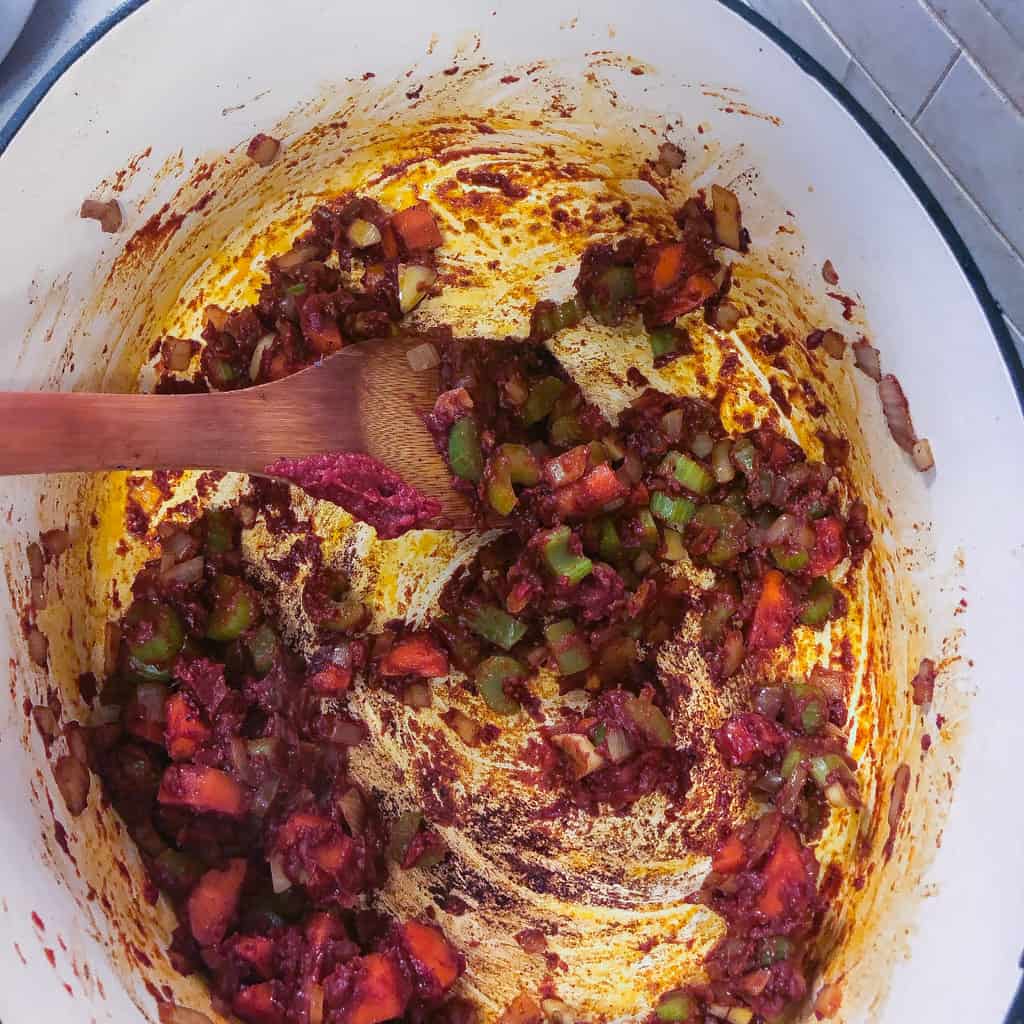 vegetables and tomato paste sauteing in pot