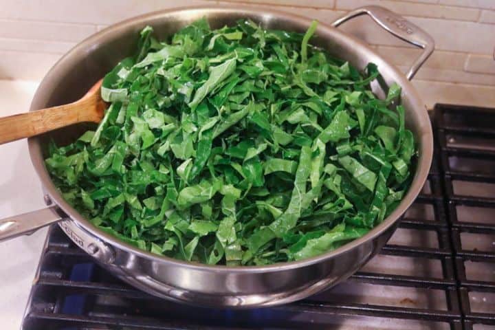 collard greens cooking in a pan