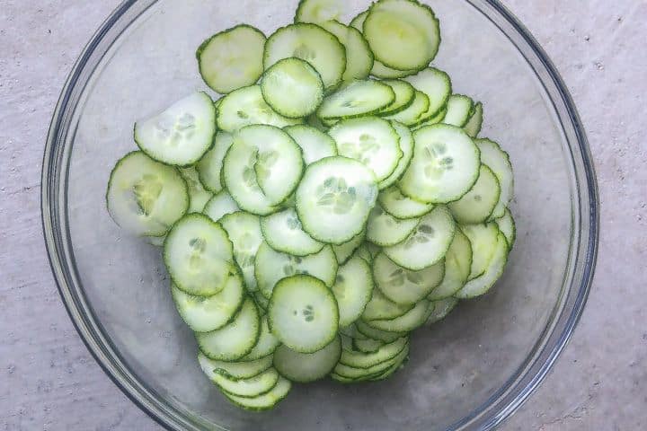 sliced cucumbers in a glass bowl