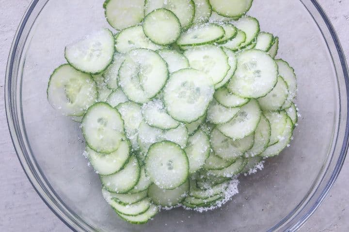 salted cucumbers in glass bowl