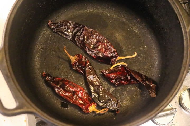 dried chilis roasting in pan