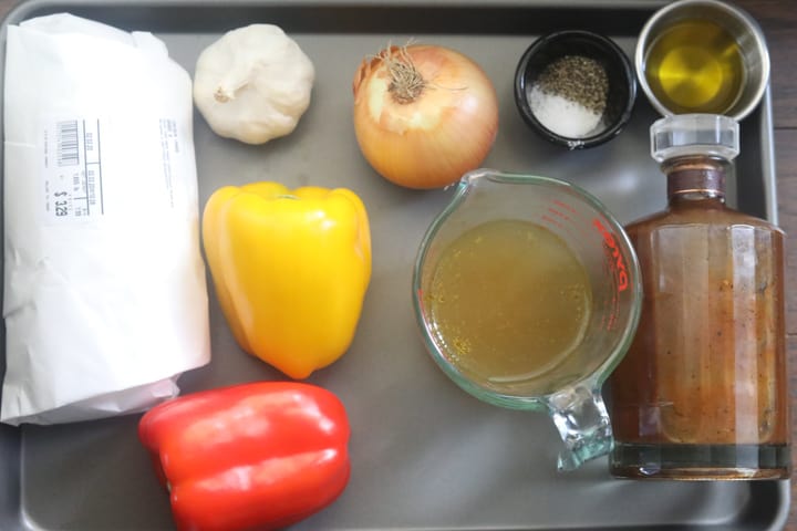ingredients for brown stew chicken on a tray