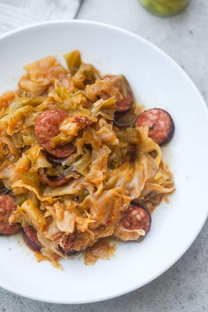 cabbage and sausage on a white plate