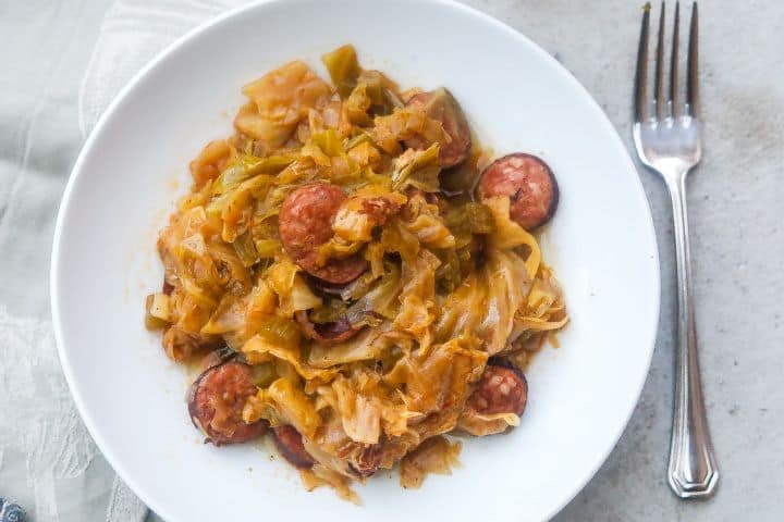 cabbage and sausage on a white plate