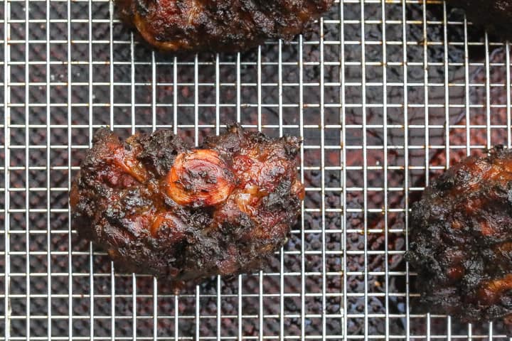 oxtails resting on a wire rack