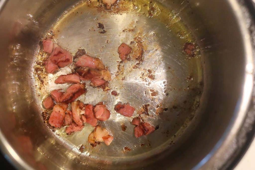 ham hocks frying in pan