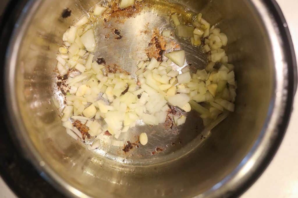 onions and garlic cooking in pan