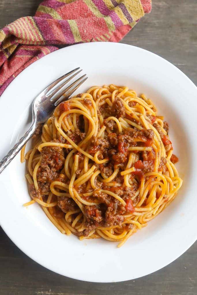 spaghetti in a white bowl with fork