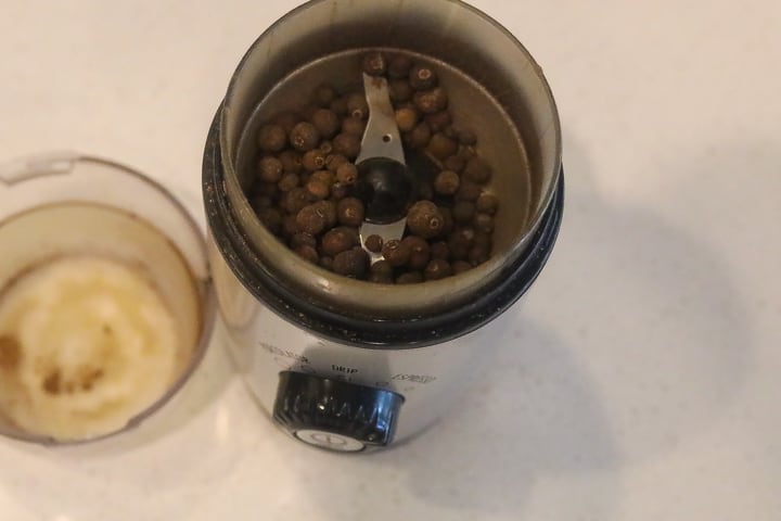 pimento berries in coffee grinder