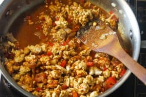ground turkey and vegetables cooking in pan