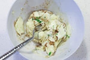 soften butter with spices in white bowl