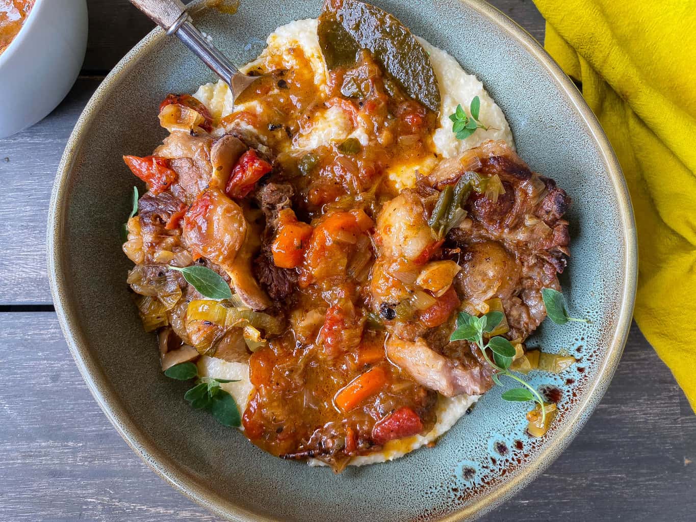 oxtails with grits in a bowl