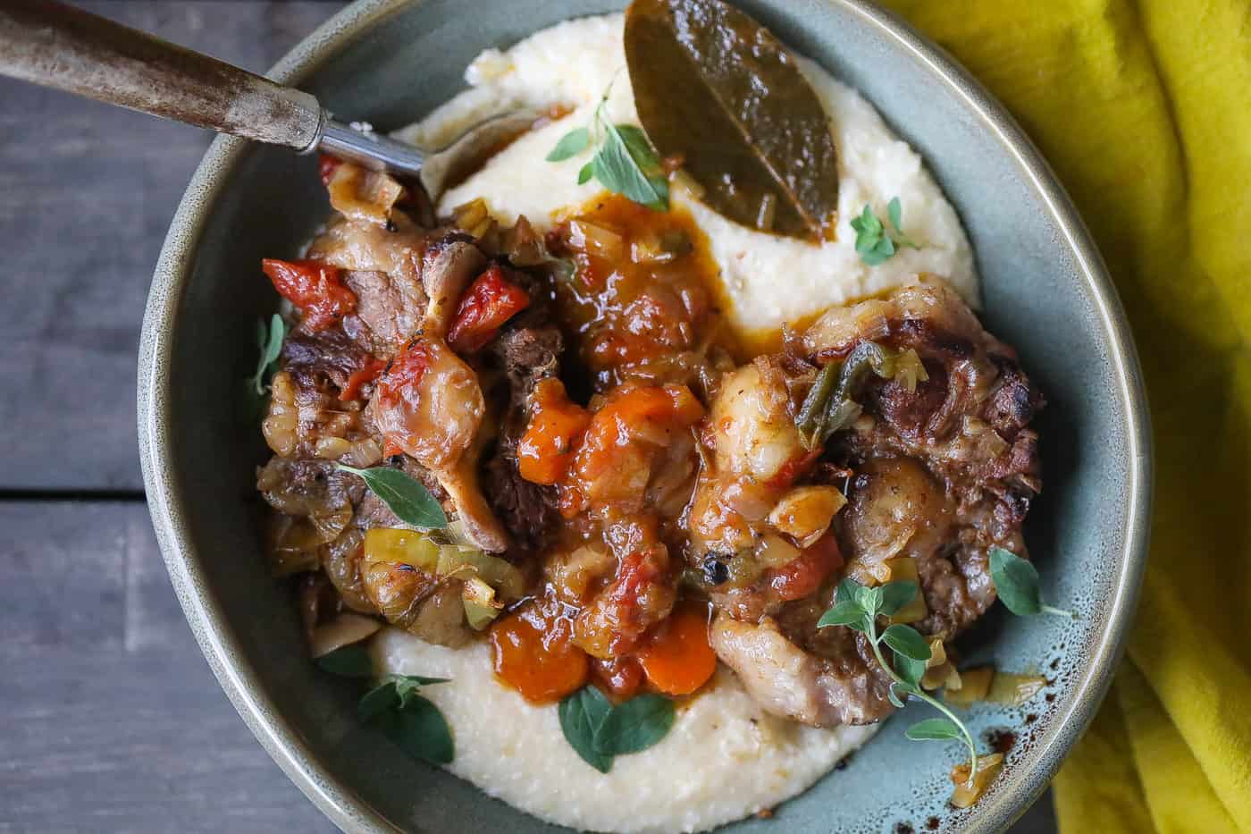 oxtails with grits in a bowl