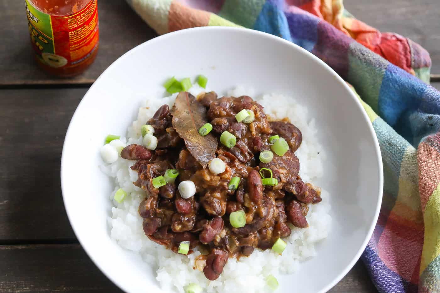 red beans and rice with sausage in a white bowl