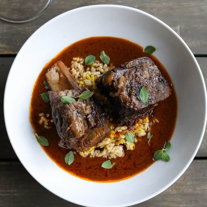 beef short ribs in white bowl with sauce