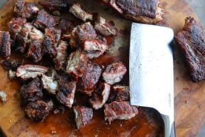 chopped ribs on wood block with meat cleaver