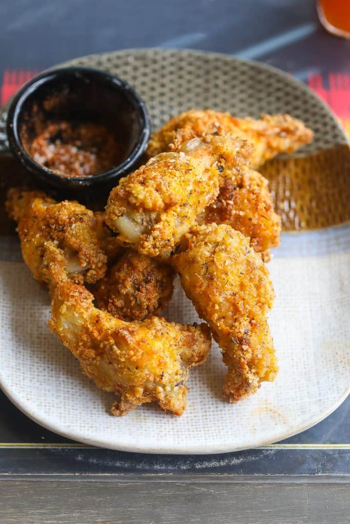 crispy chicken wings on a plate with dry spices