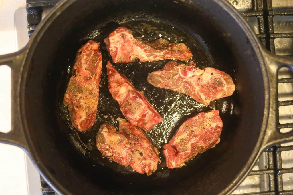 browning neck bones in a pot