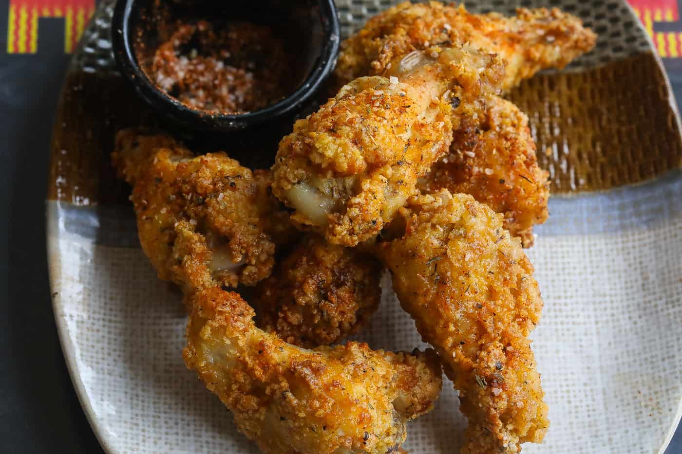 crispy chicken wings on a plate with dry spices