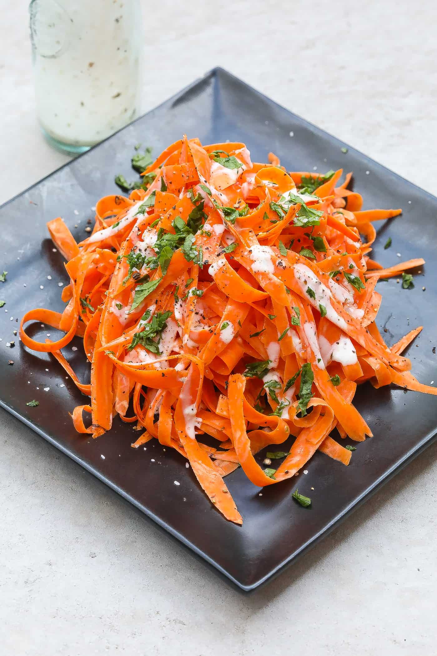 shedded carrot salad on black plate