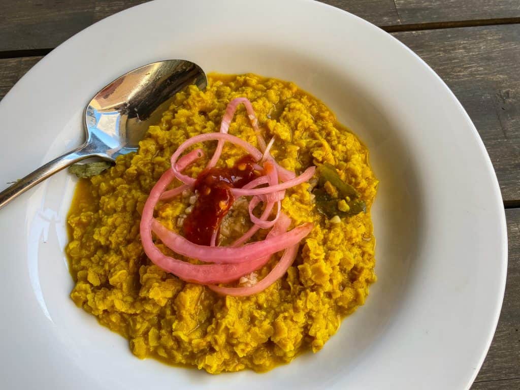 oatmeal curry topped with pickled red onions