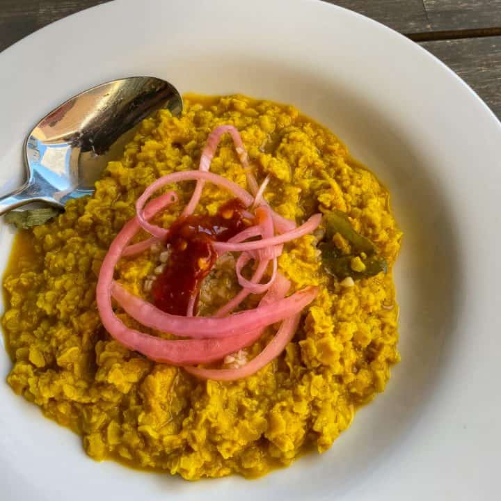 oatmeal curry topped with pickled red onions