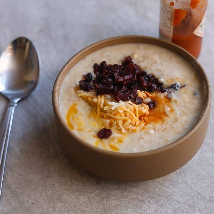 oatmeal with cheese and cranberries in a bowl