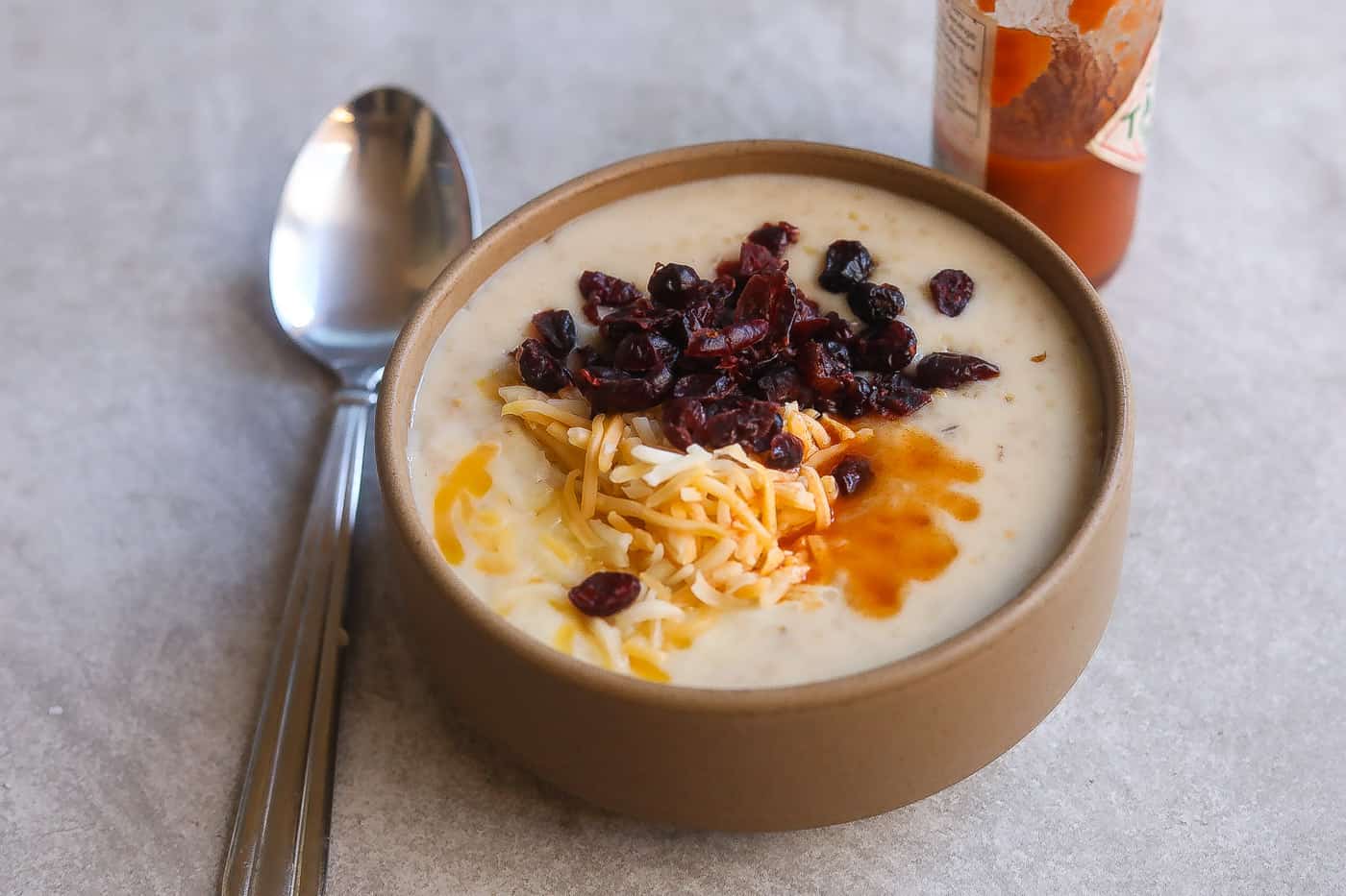 oatmeal with cheese and cranberries in a bowl