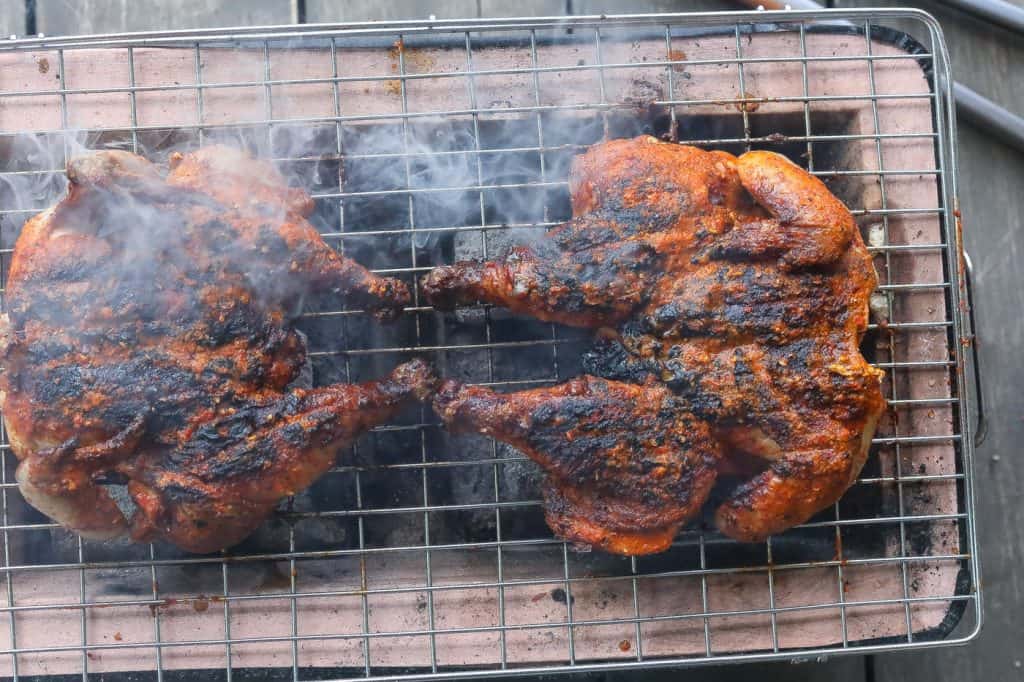 chicken grilling over flame