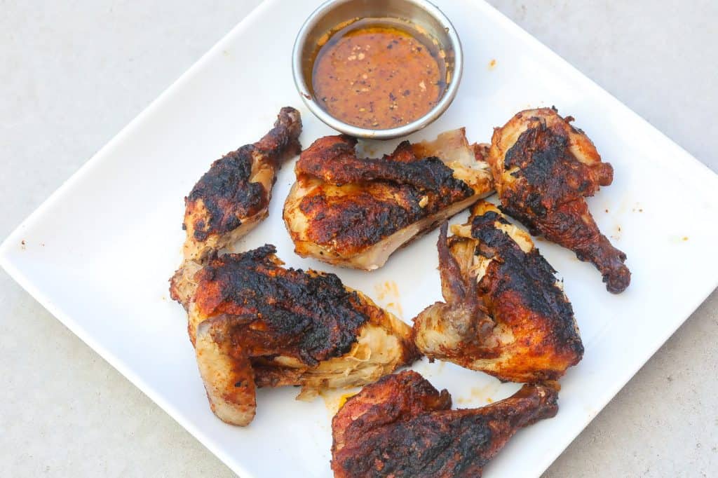 grilled chicken pieces on a white plate