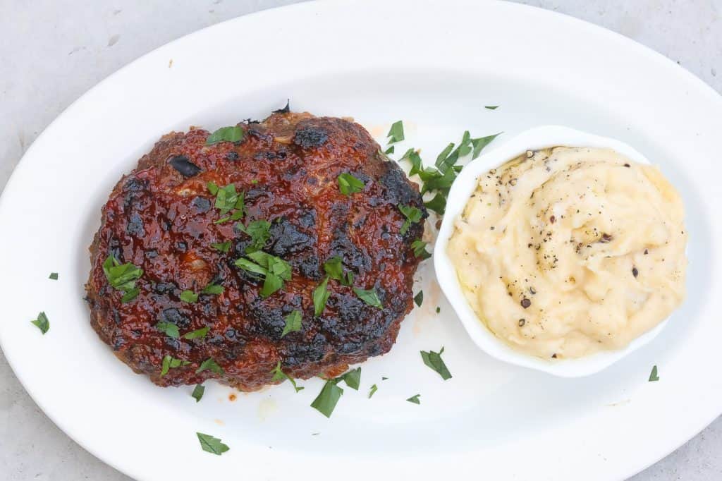 meat loaf and mashed potatoes on a white plate