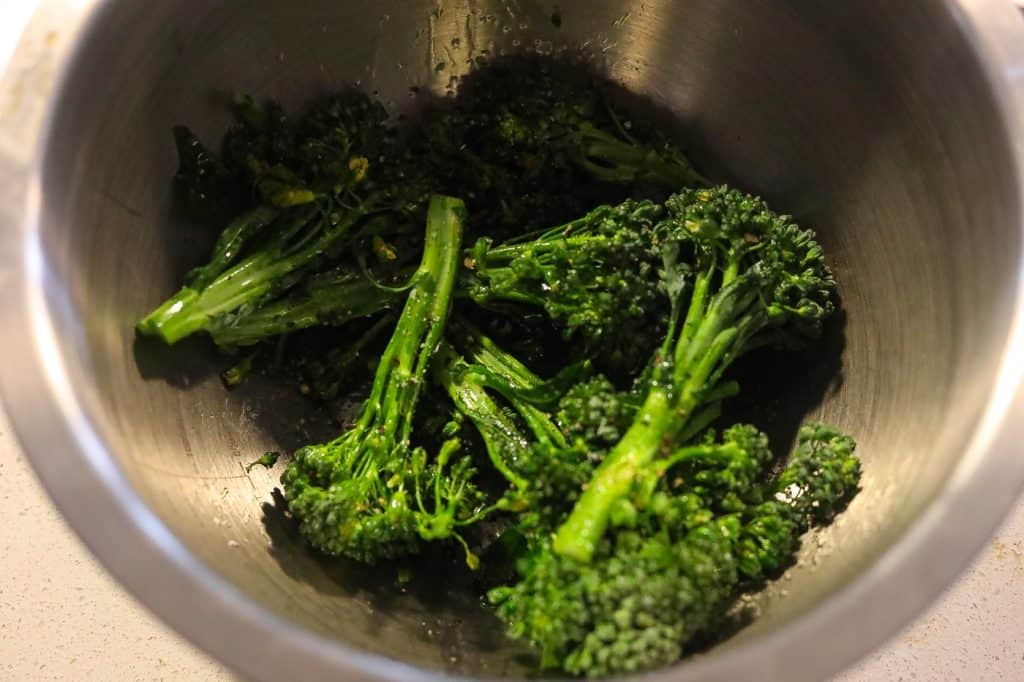 broccolini in a mixing bowl