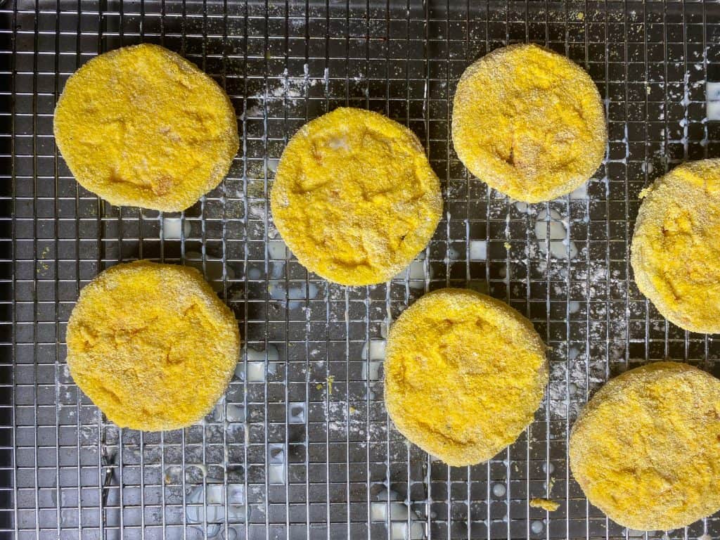 tomatoes coated with corn meal on a tray