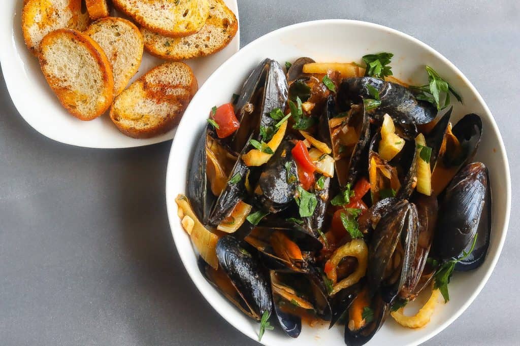 mussels in a bowl with a side of toast