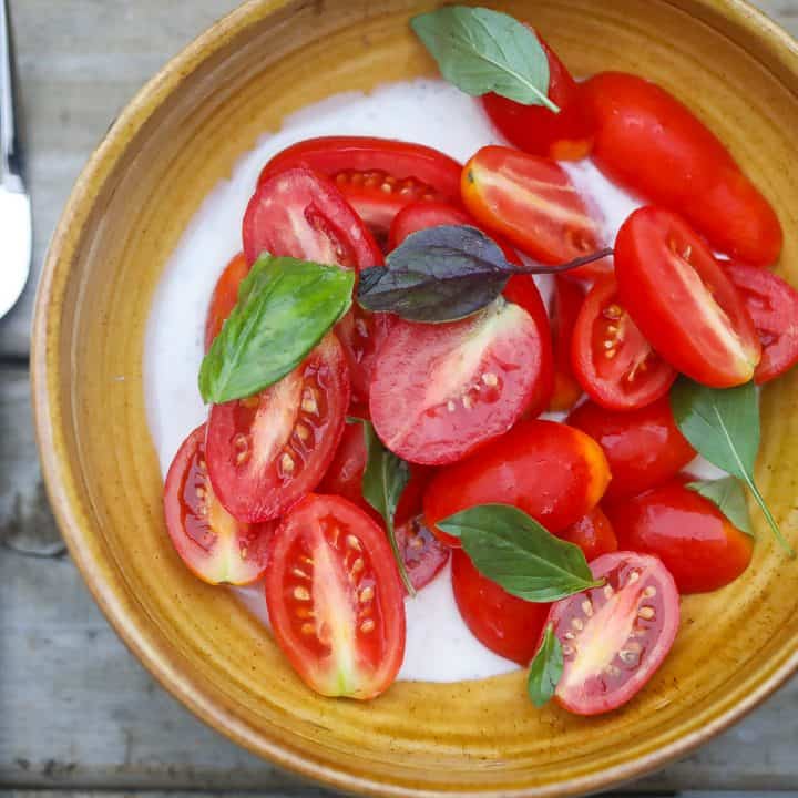 tomatoes and basil in a yellow bowl