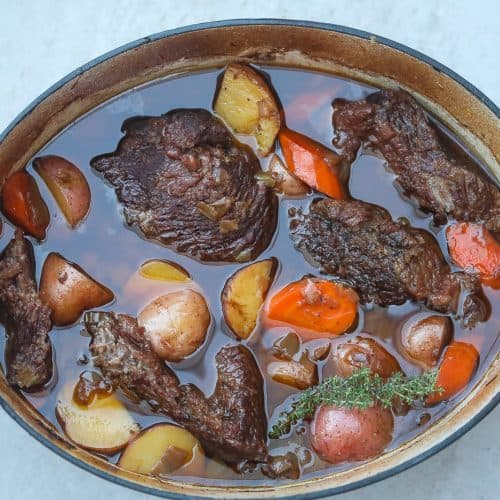 beef pot roast in a dutch with carrots and potatoes