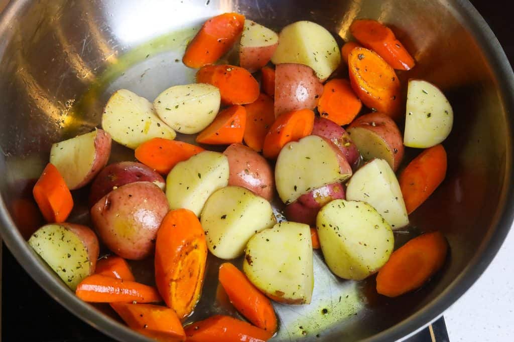 carrots and potatoes cooking in a pan