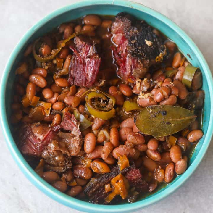 pinto beans with brisket in a blue bowl