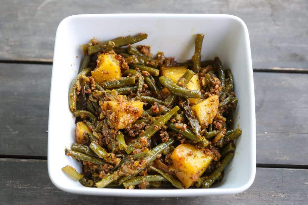 green beans and potatoes in white square bowl