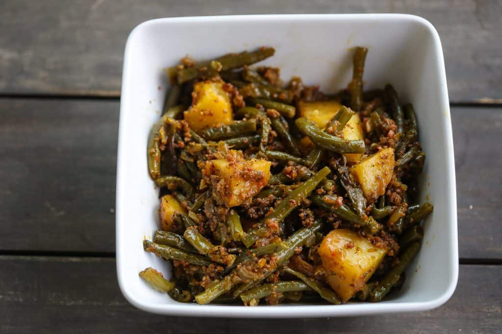 green beans and potatoes in white square bowl