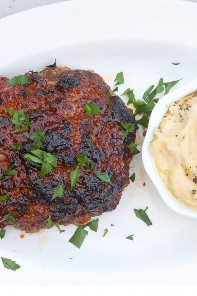 meat loaf and mashed potatoes on a white plate