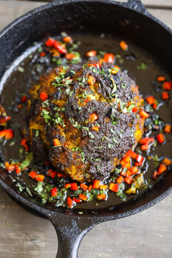 whole roasted cauliflower in cast-iron skillet