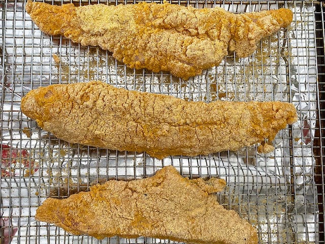 catfish breaded and sitting on a wire rack