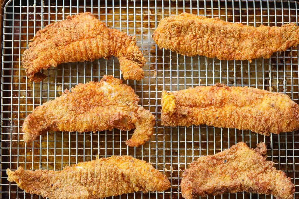 fried catfish fillets on a wire rack
